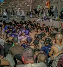  ?? AP ?? Suspected Daesh members sit inside a small room in a prison south of Mosul. —