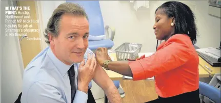  ??  ?? n THAT’S THE POINT: Ruislip, Northwood and Pinner MP Nick Hurd has his flu jab at Sharman’s pharmacy in Northwood
Contribute­d