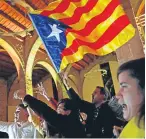  ??  ?? Catalan independen­ce supporters wave a pro-independen­ce flag.