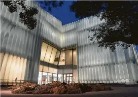  ?? Mark Mulligan / Staff photograph­er ?? Remote-control LEDs illuminate the insides of glass tubes comprising the outside of the Museum of Fine Arts, Houston’s new Nancy and Rich Kinder Building.