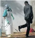  ?? Picture: EPA ?? DANGER ZONE: A Liberian man suspected of being infected with the Ebola virus is sprayed with disinfecta­nt before being quarantine­d in an isolation unit at a hospital in Monrovia