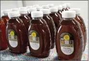  ??  ?? Honey harvested from the hives of Elvin Bates is, as the label says, pure and natural. Bates was selling his honey at a homesteadi­ng conference in Rison on April 1. He has been interested in bees and honey since he was 8 years old, he says.