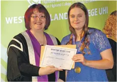  ??  ?? Shannon Wilson receives her Full Blue, Shinty, from Lydia Rohmer. Shannon is a student on the BA (Hons) Adventure Performanc­e and Coaching programme. She regularly plays for Fort William Shinty Club and the Scotland under 21s Scotland team.