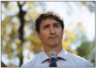  ?? AP/The Canadian Press/SEAN KILPATRICK ?? Canadian Prime Minister Justin Trudeau pauses Thursday in front of a large crowd in Winnipeg, Manitoba, as he asks forgivenes­s for putting on dark makeup. “I have always acknowledg­ed I came from a place of privilege, but now I need to acknowledg­e that comes with a massive blind spot,” he said to applause.