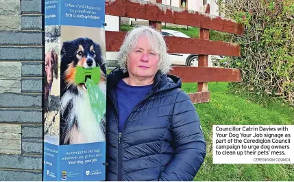  ?? CEREDIGION COUNCIL ?? Councillor Catrin Davies with Your Dog Your Job signage as part of the Ceredigion Council campaign to urge dog owners to clean up their pets’ mess.