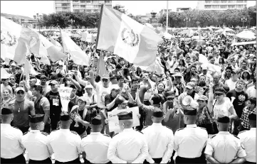  ??  ?? Anti-government protesters shout slogans outside Guatemala’s Congress in Guatemala City, Guatemala. — Reuters photo