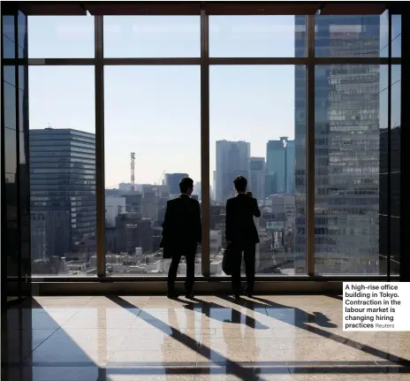  ?? Reuters ?? A high-rise office building in Tokyo. Contractio­n in the labour market is changing hiring practices