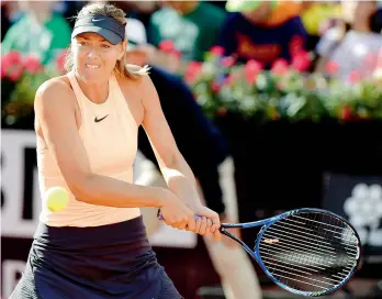  ??  ?? Maria Sharapova of Russia returns a ball to Ashleigh Barty of Australia during their match at the Italian Open tennis tournament on Tuesday. Sharapova beat Barty 7-5, 3-6, 6-2. —