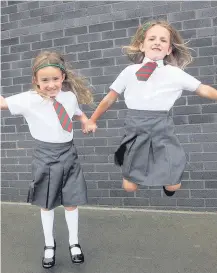  ??  ?? Jumping for joy Nicole and Rebecca Kite at St Charles’ Primary