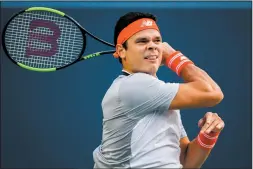  ?? CP PHOTO MARK BLINCH ?? Canada’s Milos Raonic returns a shot David Goffin of Belgium during the first round of the Men’s Rogers Cup tennis tournament in Toronto, Monday.