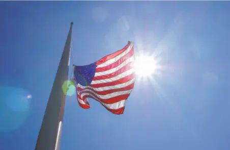  ?? Photos by Lacy Atkins / Special to The Chronicle ?? A flag flies at halfstaff in San Rafael. The symbolic gesture represents the city’s mounting frustratio­n over mass shootings.