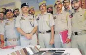  ?? HT PHOTO ?? Police officials displaying the seized mobile phones during a press conference in Katra on Friday.