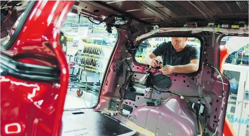 ?? GEOFF ROBINS / THE CANADIAN PRESS FILES ?? The Automotive Parts Manufactur­ers Associatio­n and autoworker­s union Unifor say approving the version of the Trans-Pacific Partnershi­p now on the table will kill Canadian auto jobs.