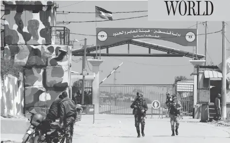  ?? MAHMUD HAMS / AFP / GETTY IMAGES ?? Hamas security forces stand guard at Erez border crossing into Israel, in Beit Hanun, in the northern Gaza Strip on Sunday. The crossing was shut down by the Islamist movement after blaming the Jewish state for the assassinat­ion of one of its officials...