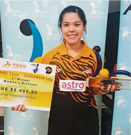  ?? Worth the effort: ?? Esther Cheah is all smiles after winning the Indonesian leg of the Asian Bowling Federation Tour in Jakarta yesterday. She beat team-mate Nur Syazwani Sahar 256-164 in the final.