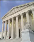  ?? AP PHOTO/JON ELSWICK ?? In this Feb. 13 file photo, people stand on the steps of the Supreme Court at sunset. The Supreme Court is returning to the familiar intersecti­on of race and politics, in a pair of cases examining redistrict­ing in North Carolina and Virginia.