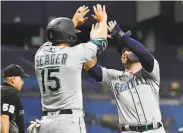  ?? Julio Aguilar / Getty Images ?? The Mariners’ Kyle Seager (15) celebrates with Ty France after both scored in the third inning.