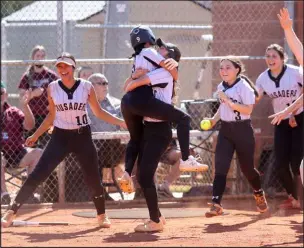  ?? K.M. Cannon Las Vegas Review-journal @Kmcannonph­oto ?? Faith Lutheran players celebrate beating Green Valley in their Class 5A Southern Region softball tournament championsh­ip game Friday.