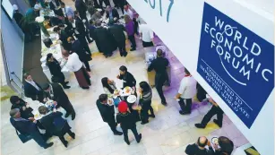  ?? (Ruben Sprich/Reuters) ?? ATTENDEES TAKE a lunch break during the annual meeting of the World Economic Forum in Davos last Friday.