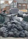  ??  ?? A mound of uncollecte­d bin bags littering a street in Birmingham.