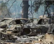  ?? PAUL KITAGAKI JR./THE SACRAMENTO BEE VIA AP ?? Vehicles and homes on Wolf Creek Road were destroyed in the Pawnee Fire in Lake County as residents were forced to evacuate and the fire continued to burn out of control on Monday, in Spring Valley, Calif.