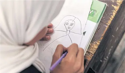  ?? THE NEW YORK TIMES ?? A photo file dated Sept 15 shows a student drawing during an art lesson at a school for girls in Kabul. Afghanista­n’s new government is likely to severely restrict education for girls and women.