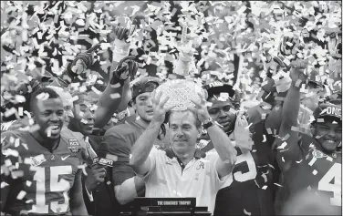  ?? Associated Press ?? Champions: Alabama head coach Nick Saban celebrates with his team after the BCS National Championsh­ip college football game against LSU in New Orleans, in this Monday, Jan. 9, 2012, file photo, Alabama won 21-0. Saban's dominating run at Alabama is more than just wins and championsh­ips. He's also ruined the careers of many of his fellow SEC coaches and cost the league's other 13 schools more than $100 million in buyouts -- all in search of someone who can knock the game's greatest coach from his perch.