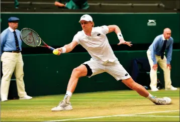  ?? ASSOCIATED PRESS ?? KEVIN ANDERSON of South Africa returns a ball to John Isner of the U.S. during their men’s singles semifinal match at the Wimbledon Tennis Championsh­ips, in London, Friday.