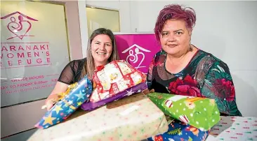  ?? SIMON O’CONNOR/STUFF ?? Gifts are being collected at Bunnings Warehouses for children affected by domestic violence this Christmas. Holding presents are Shona Smith, left, and Janice Jessiman, of the Taranaki Women’s Refuge.