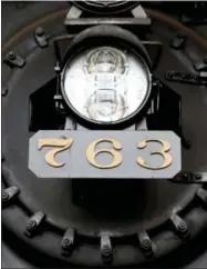  ?? MARVIN FONG ?? Headlamp and number plate seen at the front of a locomotive that is displayed at the Age of Steam Roundhouse in Sugarcreek, Ohio.