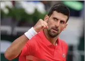  ?? Tribune News Service/getty Images ?? Serbia’s Novak Djokovic celebrates after winning against Slovakia’s Alex Molcan at the end of their men’s singles match on day four of the Roland-garros Open tennis tournament at the Court Suzanne-lenglen in Paris on Wednesday.