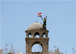  ?? (Reuters) ?? A SYRIAN regime flag displayed in Quneitra after government forces returned to the border area last year.