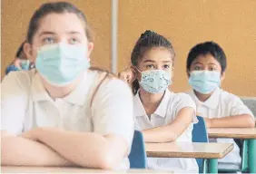  ?? GRAHAM HUGHES THE CANADIAN PRESS FILE PHOTO ?? One pediatrici­an says a face mask that is, on paper, less effective than an N95 — like a surgical mask — may be preferable to a respirator that’s too large for a small child’s face.