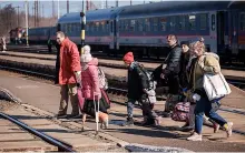  ?? Pic: Christophe­r Furlong/getty ?? Refugees fleeing Ukraine arrive in Hungary at Zahony train station on Monday