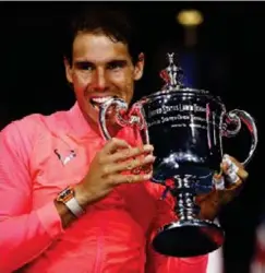  ?? (AP) ?? RAFAEL Nadal, of Spain, holds up the championsh­ip trophy after beating Kevin Anderson, of South Africa, in the men's singles final of the US Open tennis tournament, Sunday, Sept. 10, 2017, in New York.