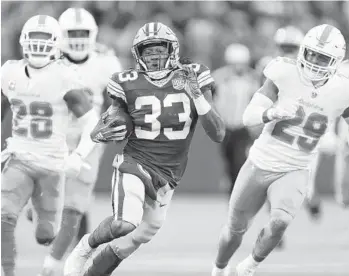  ?? MATT LUDTKE/AP ?? Packers running back Aaron Jones breaks away for a 67-yard run during the first half Sunday against the Dolphins.