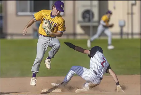  ?? Signal file photo ?? Valencia’s Kyle Rosenfield (1) steps on second base to tag out Hart’s Brayden Jefferis (2) in the 10th inning of the Foothill League baseball title game between the Hart Indians and the Vikings in Newhall at the end of the regular season.