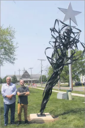  ?? STAFF PHOTO BY TIFFANY WATSON ?? Lew Martin, sculptor and owner of Indian Head Iron Works, with his apprentice welder Matt McCain, stand by the finished sculpture at La Plata Town Hall on April 29.