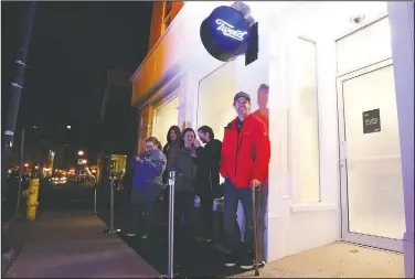  ?? AP/The Canadian Press/PAUL DALY ?? Ian Power is first in line Tuesday at the Tweed store on Water Street in St. John’s, Newfoundla­nd and Labrador. He said he hoped to make history and buy the first legal cannabis for recreation­al use in Canada after midnight.