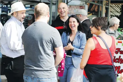  ?? CHRISTINNE MUSCHI/FILES ?? Projet Montréal leader Valérie Plante, centre, talks to patrons at Atwater Market last month. Plante wants to force condo developers to ensure that 20 per cent of the units in their projects have three bedrooms as a way of making the city more friendly...