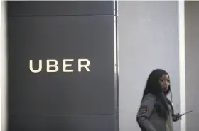  ?? Justin Sullivan / Getty Images ?? A security guard stands in front of Uber headquarte­rs in San Francisco. The company’s struggles are drawing lots of attention, even in business schools.