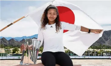  ??  ?? Sweet victory: Naomi Osaka posing with the trophy after beating Daria Kasatkina in the women’s singles final of the Indian Wells Masters in California on Sunday. — AFP