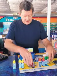  ?? ROSALIE RAYBURN/JOURNAL ?? Doug Massey, owner of Pool Works, shows the components of a pool water test kit. He recommends pool and spa owners test the chemical balance of the water several times a week.