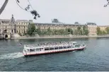  ??  ?? River cruise . . . Travel the Seine by boat; the Louvre is in the background.