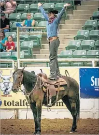  ?? Becky Papa ?? AT RENO RODEO, trainers demonstrat­e how well they have conditione­d wild horses collected from crowded land.