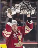  ?? The Canadian Press ?? Jeffrey Truchon-Viel, captain of the QMJHL’s Acadie-Bathurst Titan, hoists the Memorial Cup after defeating the Regina Pats in the championsh­ip game on Sunday.