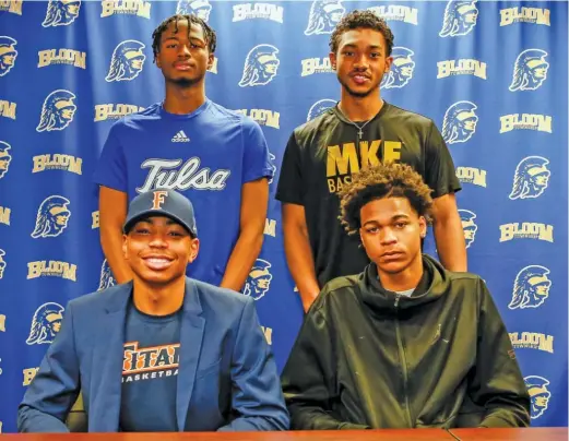  ?? KIRSTEN STICKNEY/FOR THE SUN-TIMES ?? Dante Maddox Jr. (clockwise from lower left), Keshawn Williams, Donovan Newby and Martice Mitchell on national signing day at Bloom.