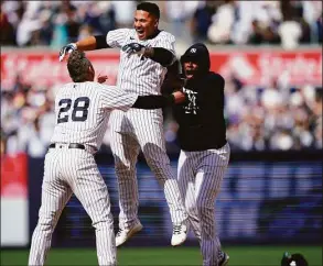  ?? Frank Franklin II / Associated Press ?? The New York Yankees’ Gleyber Torres, center, celebrates with Josh Donaldson after driving in the winning run during the ninth inning against the Cleveland Guardians on Saturday.