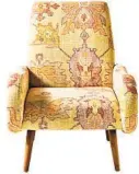  ?? ANTHROPOLO­GIE ?? The upholstery of the Kennett chair looks exactly like a kelim. The authentic overdyed look in maize actually is a digital print on cotton. The frame is tropical hardwood with oak wood canted legs. It’s 37 inches tall, 32 inches wide and 39 inches deep.