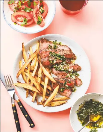  ?? Excerpted from The Make-Ahead Sauce Solution © Elisabeth Bailey, photograph­y © by Joseph De Leo Photo ?? Pan-fried steak with chimichurr­i, French fries, and tomato salad.